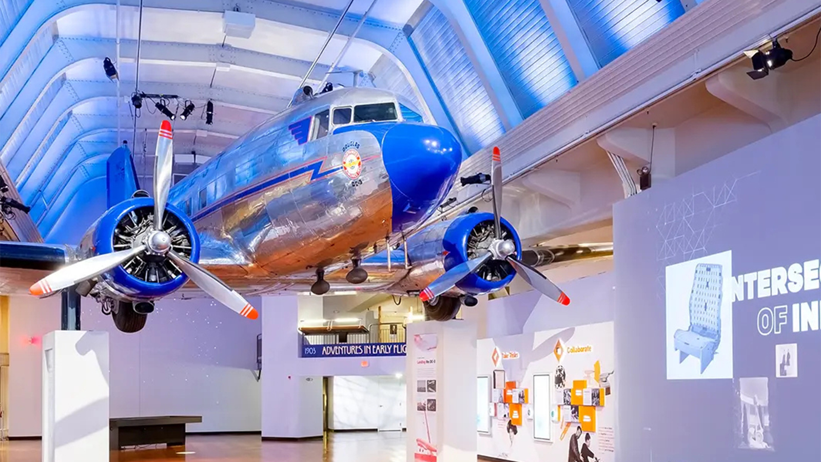 Historic propeller aircraft displayed indoors in a museum exhibit.