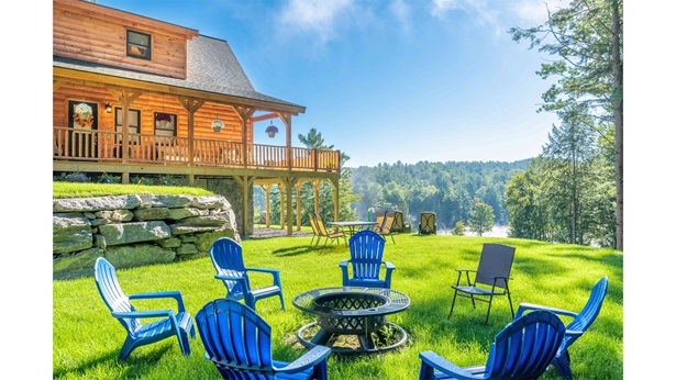 Fire pit with chairs and a cabin behind