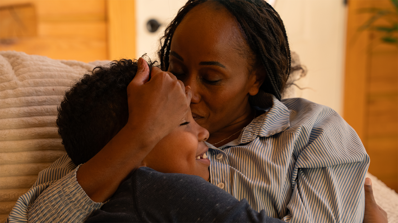 Mother hugging son in Gastineau home