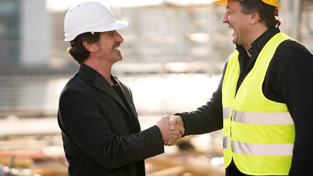 Men shaking hands at a construction site