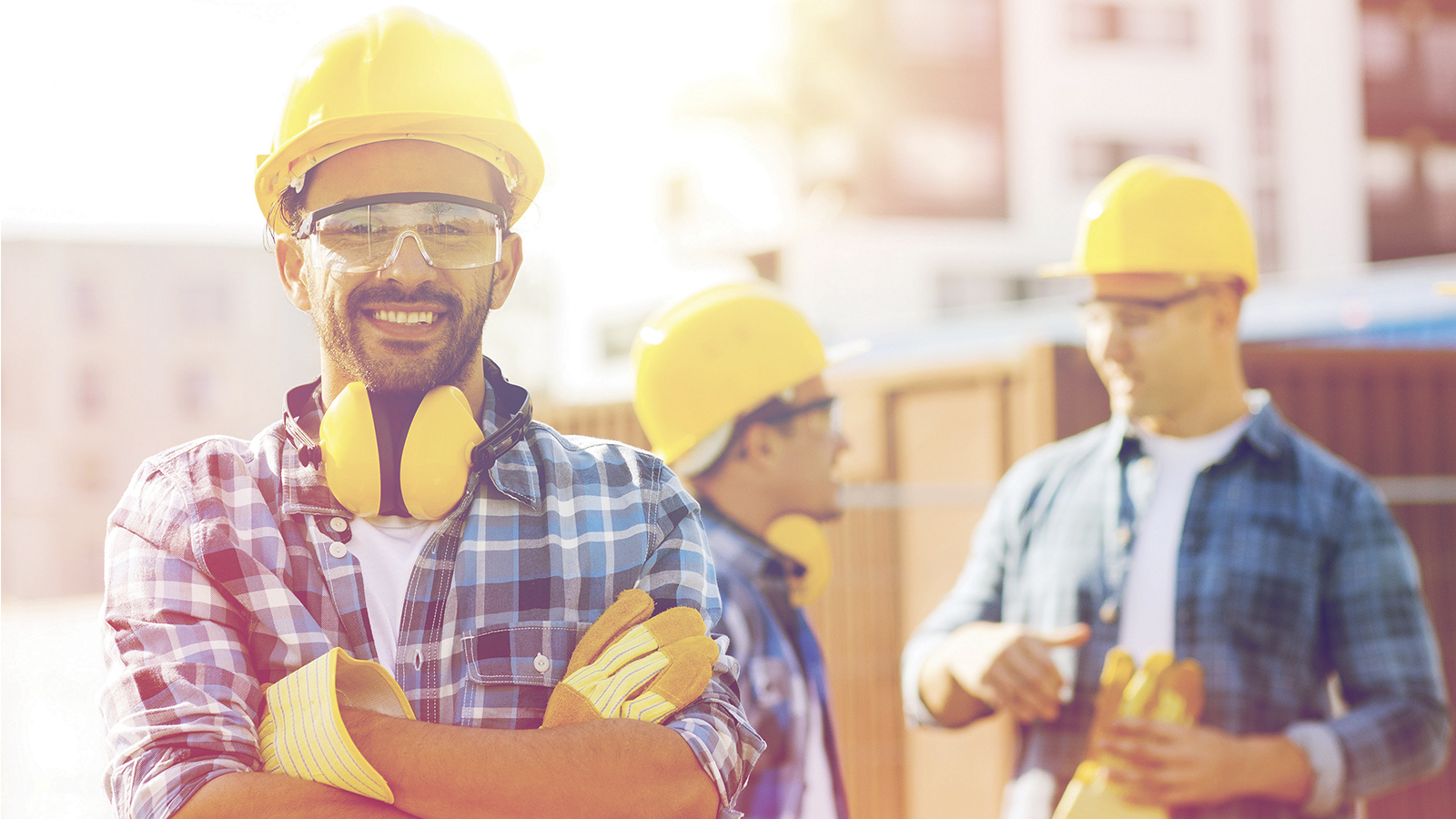 Construction worker with arms crossed smiling