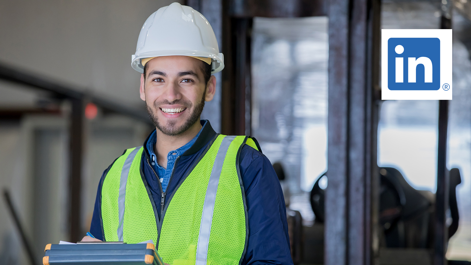 Man in hard had and reflective vest smiling