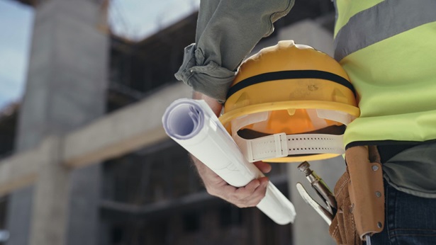 Closeup of a contractor standing at a construction site.
